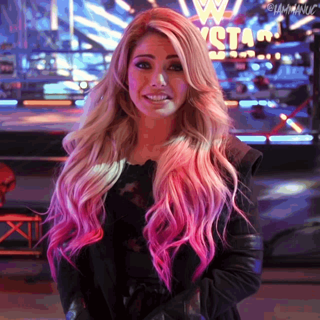 a woman with long blonde and pink hair stands in front of a sign that says w stars