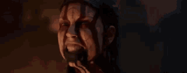 a close up of a woman 's face with blood coming out of her mouth .