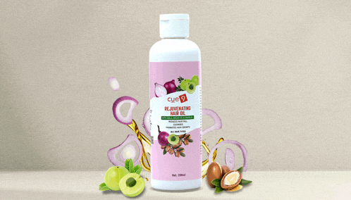 a bottle of cue rejuvenating hair oil surrounded by fruits