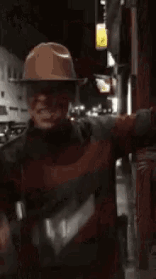 a man dressed as a nightmare before christmas character is holding a gun .