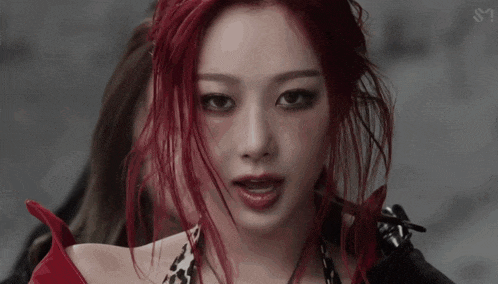 a close up of a woman 's face with red hair .