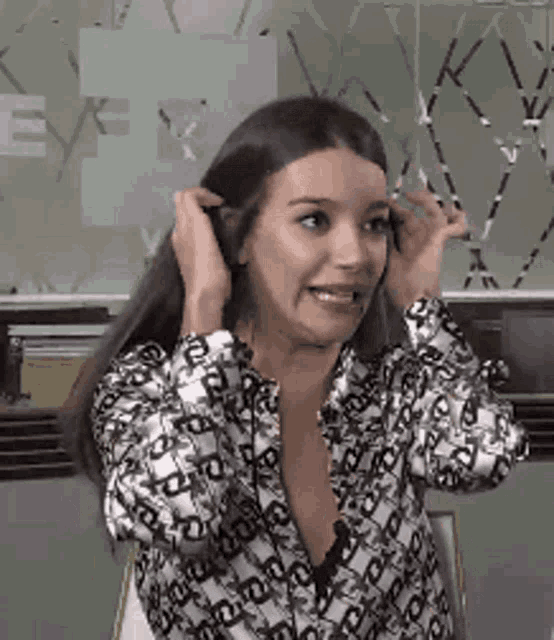 a woman wearing a black and white shirt with the letter e on it