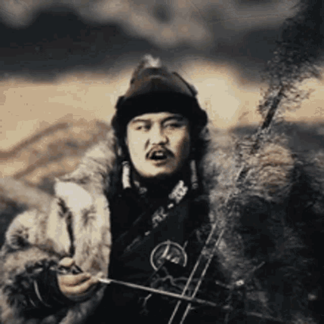 a man in a fur coat holding a sword