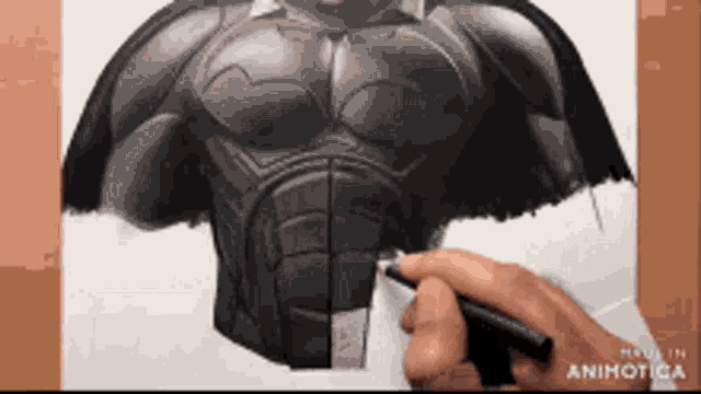 a person is drawing a batman with a pen