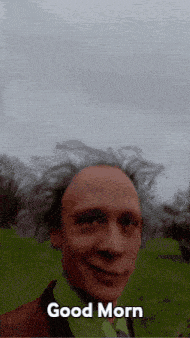 a man says good morn in front of a field