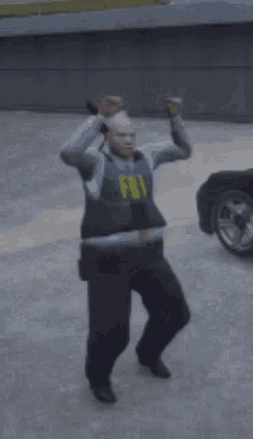 a man in a fbi vest is dancing in a parking lot with his arms in the air .