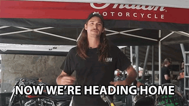 a man stands in front of an indian motorcycle tent and says " now we 're heading home "
