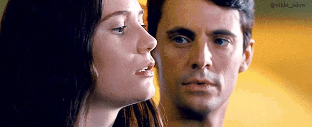 a man and a woman are looking into each other 's eyes .