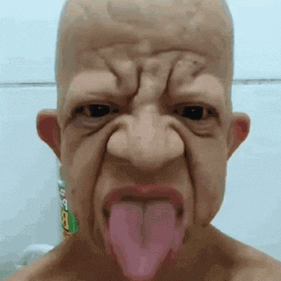 a man wearing a mask with his tongue hanging out