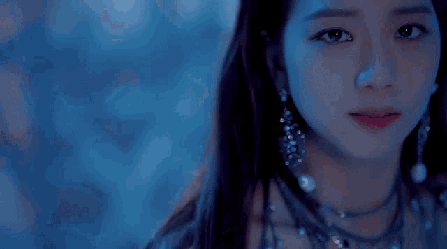 a close up of a woman 's face against a blue background .