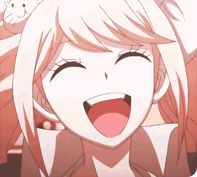 a close up of a girl 's face with a big smile on her face