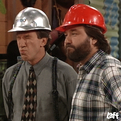 two men wearing hard hats one of which says timbo on it