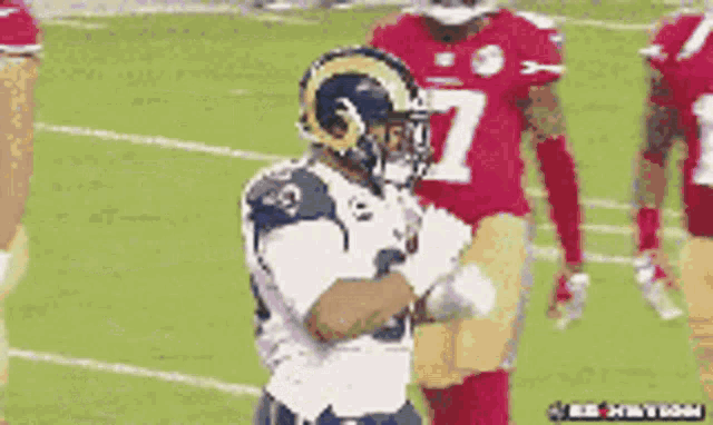 a football player wearing a helmet with rams on it