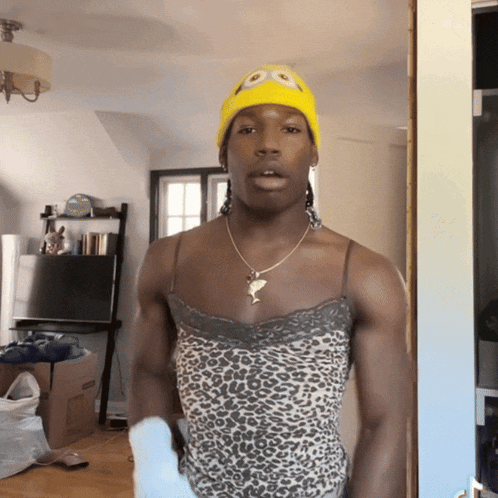 a man wearing a yellow minion hat and a leopard print top