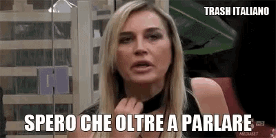 a woman is wearing a choker and has the words spero che oltre a parlare written on her face .