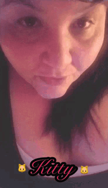 a close up of a woman 's face with the word kitty on the bottom