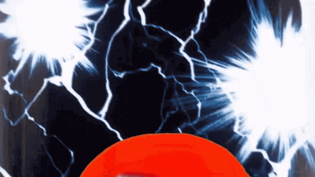 a close up of an orange frisbee with a lightning bolt in the background