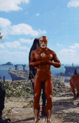 a man in a red superhero suit is standing in front of a boat