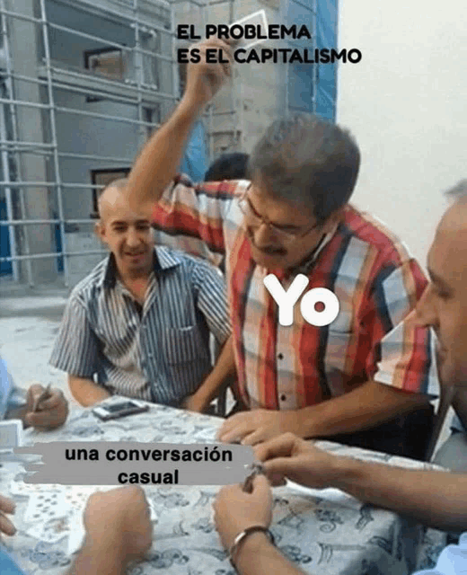 a group of men are sitting around a table and one of them has a yo logo on his shirt