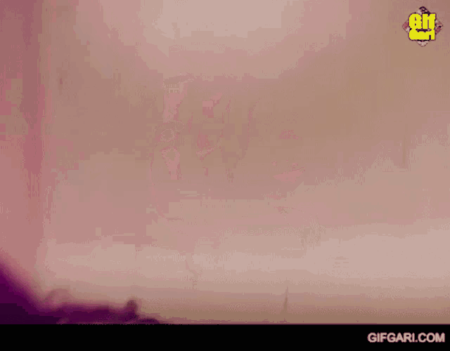 a blurry picture of a person 's face with the words gifgari.com on the bottom right