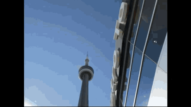 looking up at the cn tower and a sign that says ' cn tower ' on it