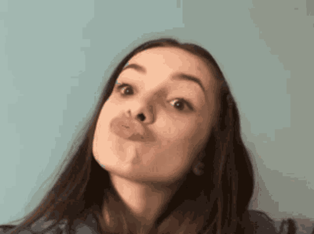 a woman is making a funny face with her lips