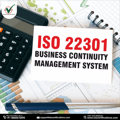 iso 22301 business continuity management system is written on a piece of paper next to a calculator