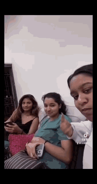 a group of young women are sitting on a couch .