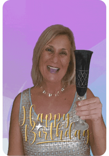 a woman is holding a champagne glass with the words happy birthday written on it