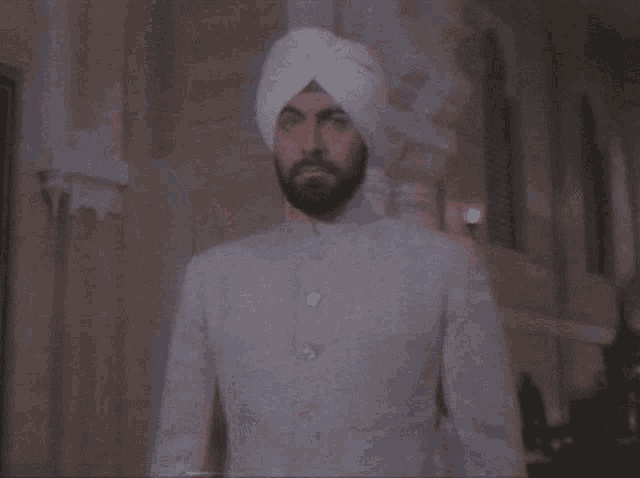 a man with a beard and a white turban on his head