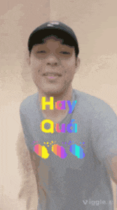 a man wearing a hat and a t-shirt that says hay qua on it
