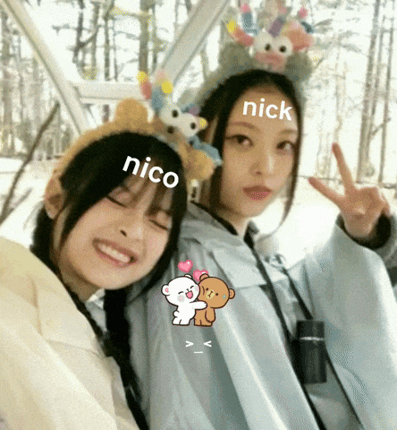 two girls are posing for a picture and one of them has the name nick on her head