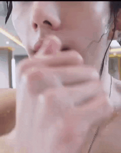 a close up of a woman 's face with water coming out of it .