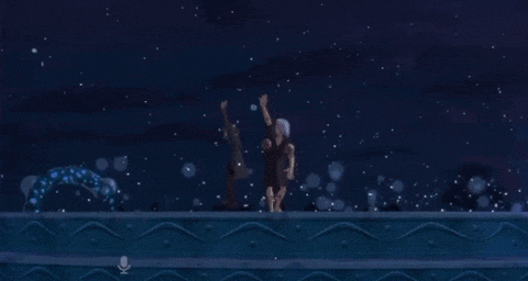 a man and a woman are standing in the water at night .