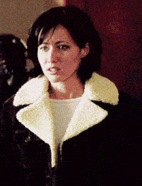 a woman in a brown jacket with a white collar