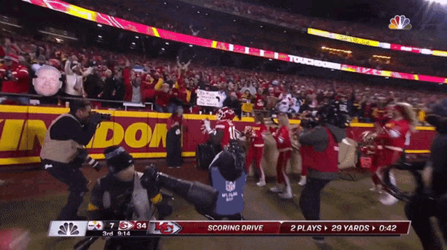 a scoreboard at a football game shows that the chiefs have scored a touchdown