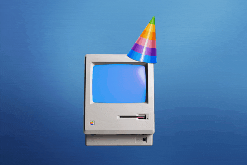 an apple computer with a party hat on top