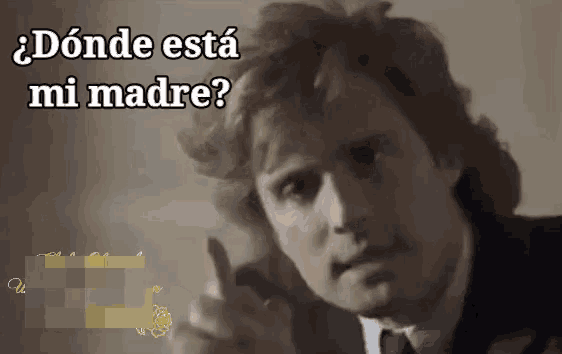 a man in a suit and tie is giving a thumbs up with the words " donde esta mi madre " above him