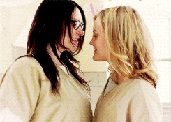 a couple of women are looking at each other and smiling