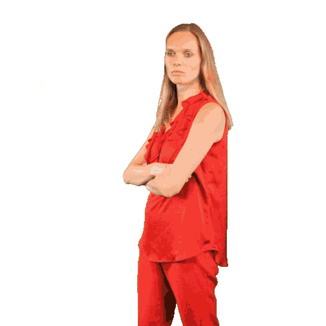 a woman in a red top and red pants is pointing her finger