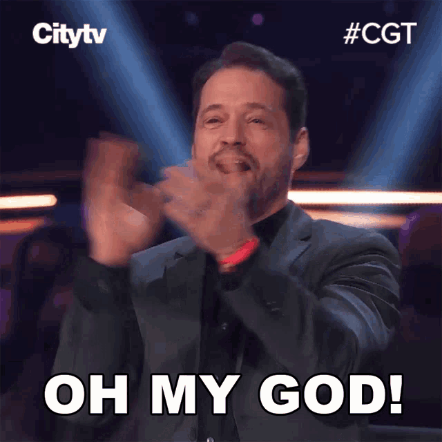 a man in a suit applauds with the words oh my god above him