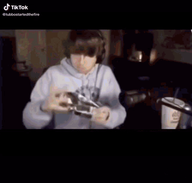 a person is playing a video game in a minecraft world while another person looks on .