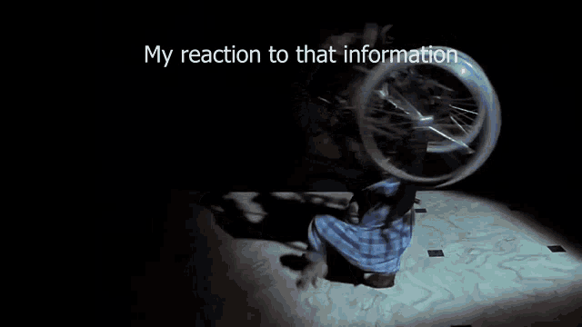 a man in a plaid shirt is laying on the floor with a wheelchair behind him and the words my reaction to that information