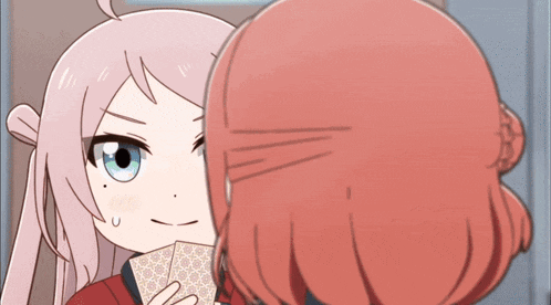 two anime girls are playing a game of cards and one of them is holding a card in her hand