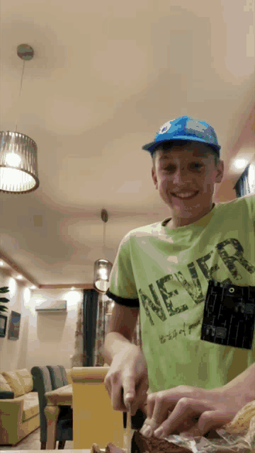 a young boy wearing a green shirt that says never