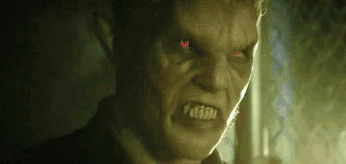 a close up of a man with red eyes .