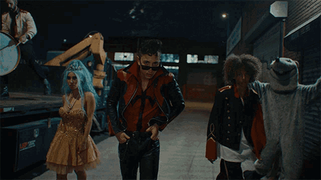 a man in a red jacket is standing next to a group of people