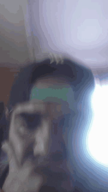 a blurry picture of a man with a green headband on