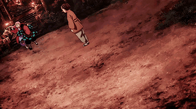 a couple of people standing on a dirt road with a staircase in the background