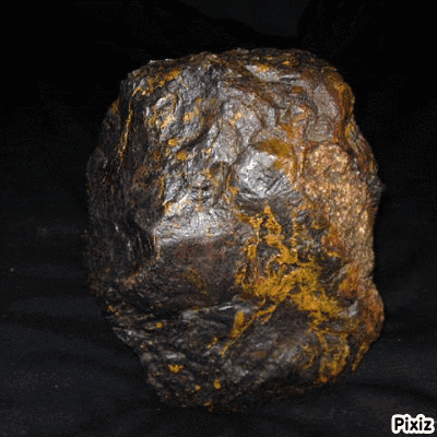 a large rock with pixiz written on the bottom left